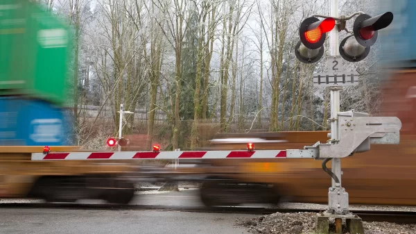 an image of a rail crossing and train