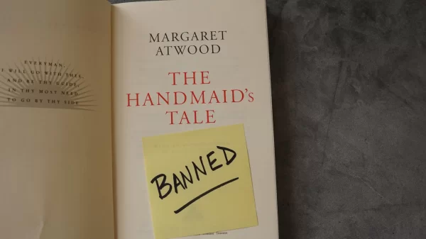 Title page inside a copy of The Handmaid's Tale by Margaret Atwood with a note saying "banned." The book has landed on many school and library banned book lists.