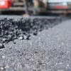The image is blurred in the construction of asphalt road. With heavy machinery