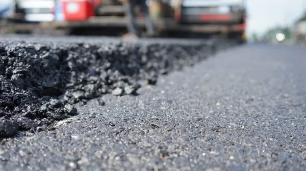 The image is blurred in the construction of asphalt road. With heavy machinery