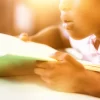 Girl reading a book in the classroom