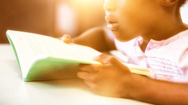 Girl reading a book in the classroom