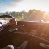 Truck driver keeps driving with one hands and change gears,The man Behind Semi Truck Steering Wheel,spot focus.