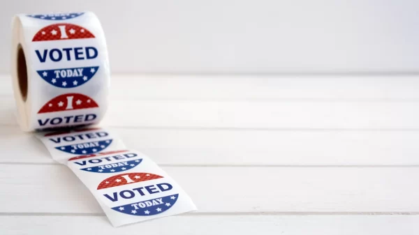 Roll of I Voted Today stickers on white wooden table with copy space. US presidential election concept