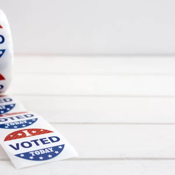 Roll of I Voted Today stickers on white wooden table with copy space. US presidential election concept