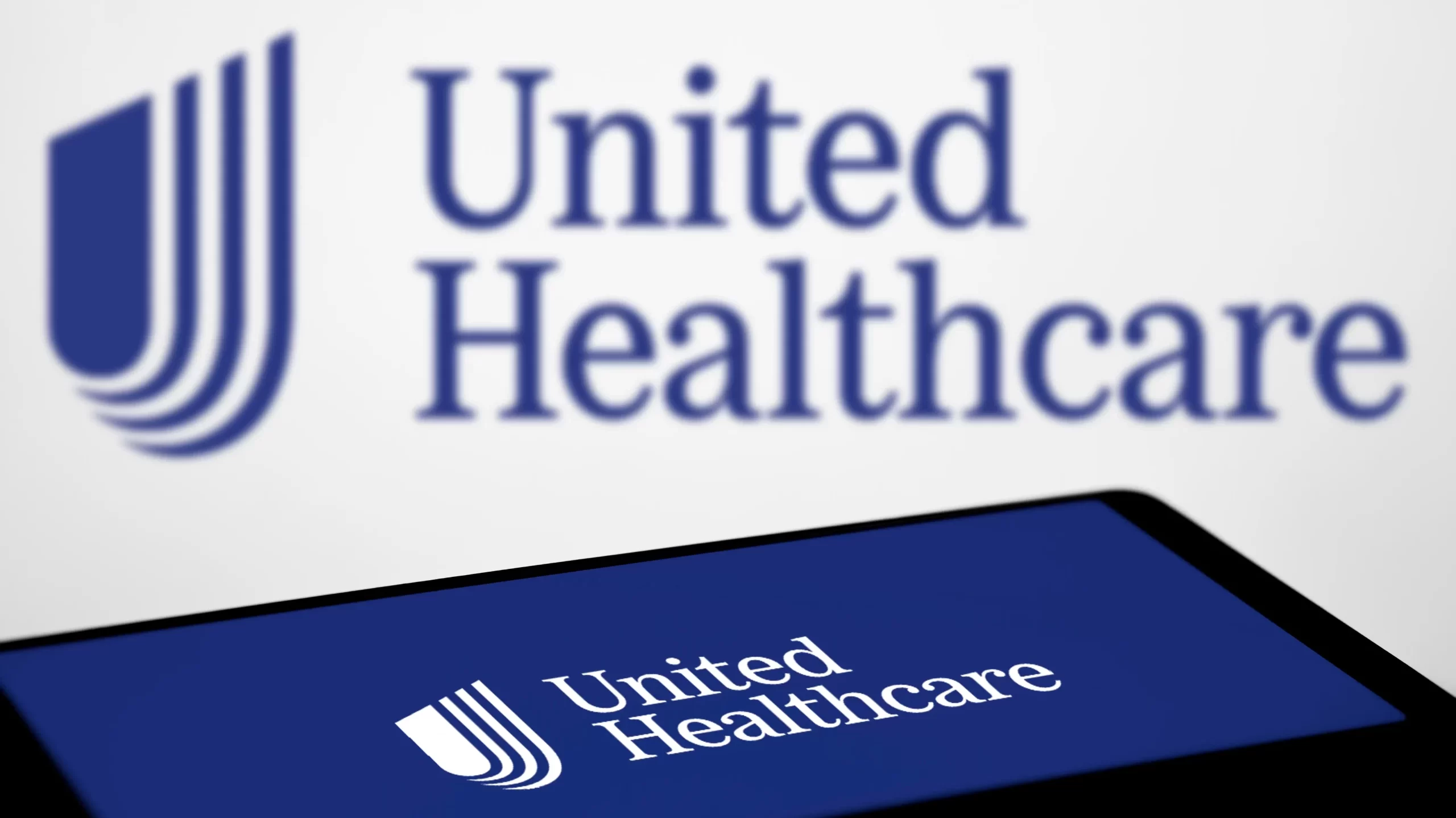 United Healthcare logo is displayed on smartphone.