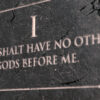 A view of the first commandment etched into a cracked stone tablet on an isolated background - 3D render