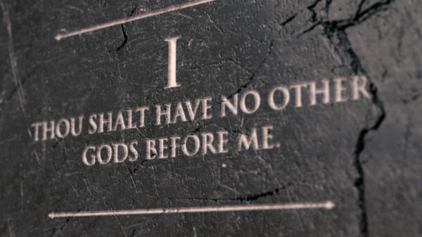 A view of the first commandment etched into a cracked stone tablet on an isolated background - 3D render